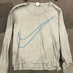 Gray Nike shirt with blue Swoosh